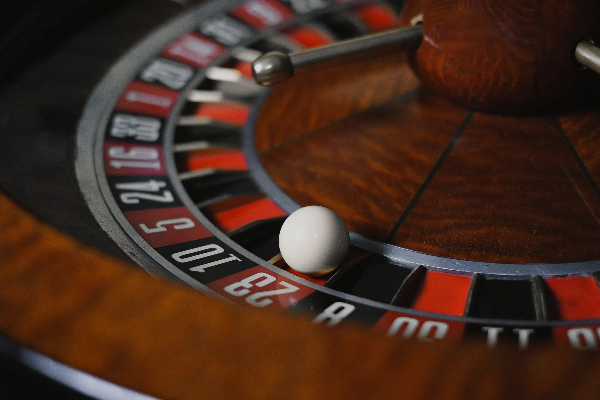 Roulette wheel under red casino light